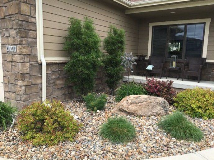 Front-yard landscaping with rock and shrubs